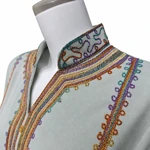 Close view of the V-notch stand collar and multicolored chest embroidery