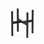 One black metal plant stand with four upright legs on white