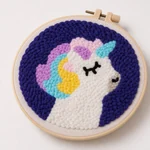 Close view of a completed pattern 3 unicorn embroidery with textured yarn loops.