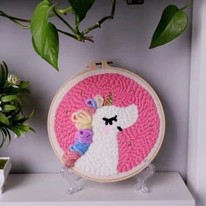Pattern 1 option preview showing a completed punch needle sample of unicorn head with pastel mane.