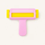 Pink paper crimper viewed from above, showing its yellow rollers and T-shaped grip
