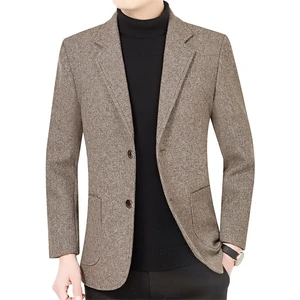 Model wearing a khaki men’s blazer over a black top, front view with notched lapels and lower patch pockets.