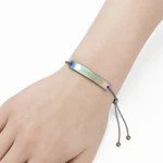 Rainbow-finish music-code bracelet worn on a wrist