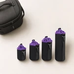 Four black and purple lens pouches lined up by size beside a black camera bag