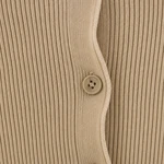 Close-up of the beige cardigan's knit texture and small matching front buttons