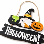 Angled close-up of gnome hat, cauldron and pumpkin