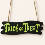 Green Trick or Treat lettering on the black lower plaque