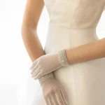 White gloves worn with a bridal outfit, showing the wrist cuffs