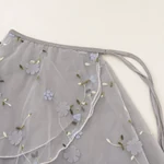 Close-up of the gray floral skirt layers and wrap ties