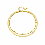Gold double-layer stainless steel anklet arranged on a clean white background