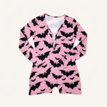 Pink bat-print romper laid flat from above