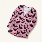 Side angle of pink bat-print romper and short legs