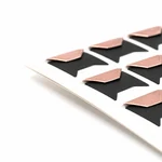 Side view of rose-gold folded corners on their backing sheet