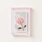 Pale pink transparent-edge acrylic frame displaying a flower photo
