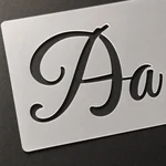 Close-up of the Aa stencil sheet showing the letter-shaped openings.