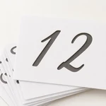 Numeral 12 stencil sheet above the thin layered edges of the PET sheets.