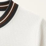 Close-up of the white knit texture and dark ribbed collar with brown and white stripes