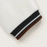 Close-up of a white knit sleeve cuff with a dark band, fine white stripe and brown outer edge