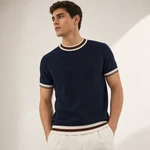 Adult man wearing the navy-blue knit top with contrast-trimmed crew neck, short sleeves and hem