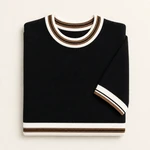 Folded black knit top viewed from above, showing striped collar and sleeve cuff