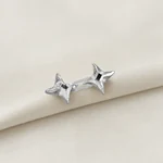 Linked star fastener resting on folded denim