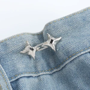 Silver: two linked four-point stars with dark center accents on blue jeans