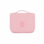 Closed pink toiletry bag on a clean white background, front handle and stitched patch visible