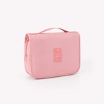 Angled view of the closed pink case showing its side depth and zipper pull
