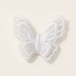 Close-up of the white butterfly appliqué showing its embroidered outline and layered organza wings.