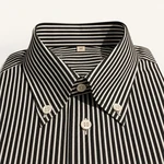 Close view of a black-and-white striped shirt with buttons fastening both collar points
