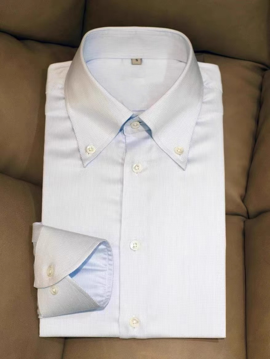 Folded White Style 2 shirt with a visible button at each collar point and a buttoned cuff