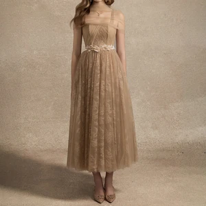 Champagne lace midi dress with two straps, a straight neckline, draped sheer bodice, floral waist trim, and layered skirt.