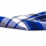 Low side view of a fold in blue, white and black plaid fabric