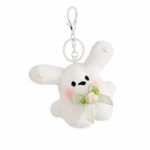 Full view of the white rabbit charm with original clasp, ring, green bow and cream flower