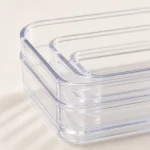 Close-up of stacked clear organizer trays showing their rounded corners