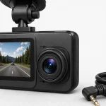 Close view of the main dash camera lens and screen beside a right-angle cable plug