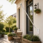 Flag pole without a flag shown angled outward from an exterior wall beside a window