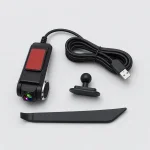 Black car camera beside a coiled USB cable, a small mount and a long trim tool