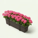 Angled view of pink artificial flowers in a long dark planter with mounting brackets