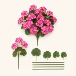 Artificial pink flower bunch laid beside separate flower stems and green leaves