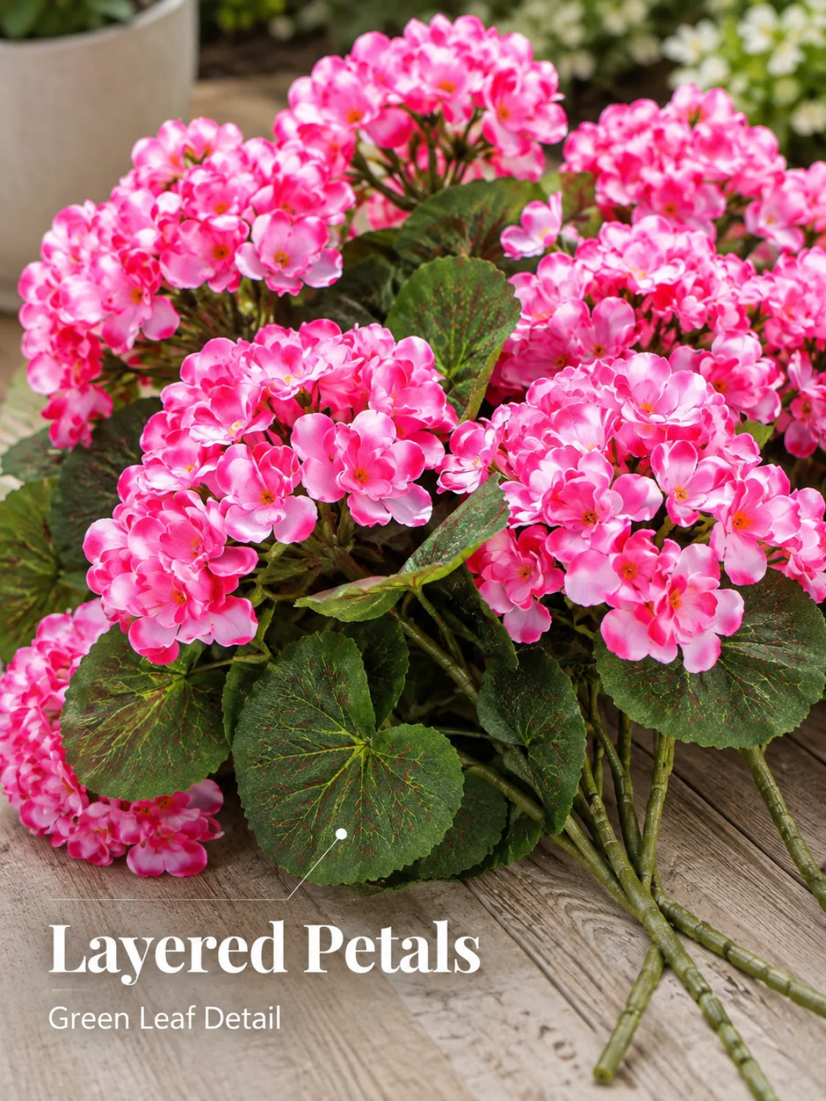 Layered artificial geranium petals and green leaves close up