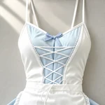 Blue style example: Decorative criss-cross lacing and gingham bow on the blue and white dress