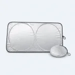 Silver windshield sunshade opened flat beside its round storage pouch.
