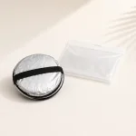 Windshield sunshade folded into a round bundle and secured with a black strap.