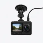 Compact black dash camera with a small screen, round lens and suction mount