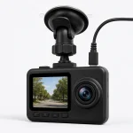 Close view of a dash camera screen, lens and four buttons below the screen