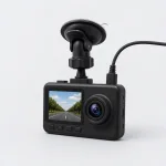 Angled dash camera showing its side slots, top cable and suction mounting arm