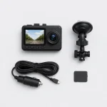 Dash camera laid out beside a detached suction mount, vehicle power cable and rectangular pad