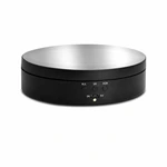Black electric display turntable with a reflective silver top and three front buttons on a white background