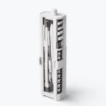 Angled view of an upright white cleaning kit showing tool slots, side tips and a top knob